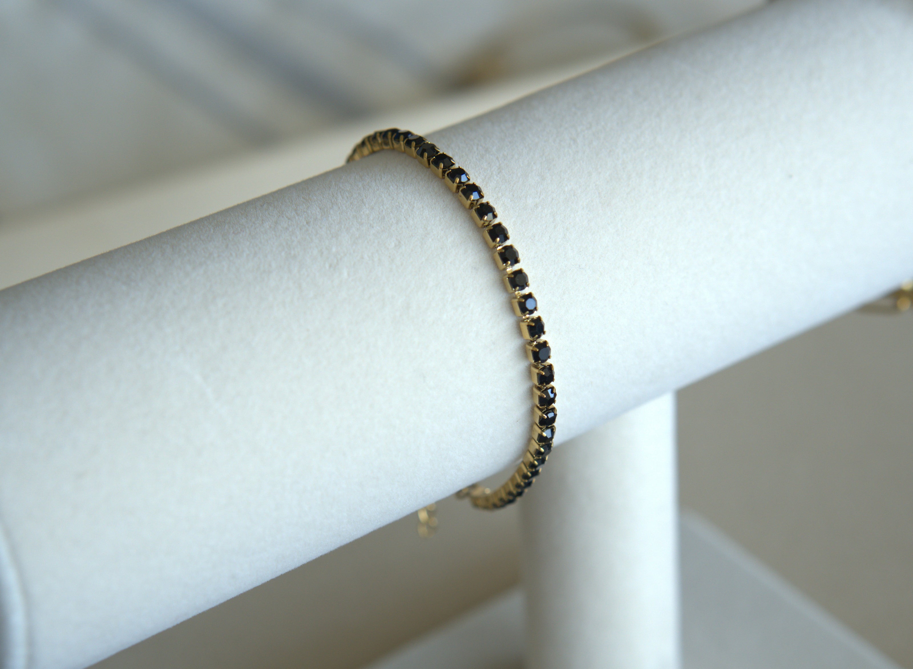 Bracelet with black stones on a white mannequin arm