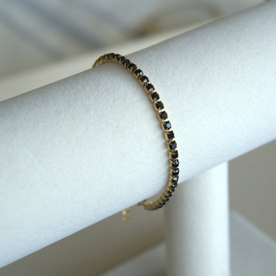 Bracelet with black stones on a white mannequin arm